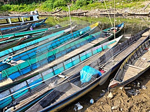 Fishing boats are moored on the edge of a reservoir