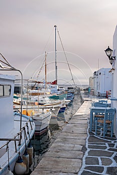 Fishing boats moored at the harbor dock. Greece, Paros island Naousa old port