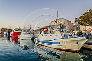 Fishing boats moored on the quay photo