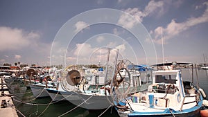 Fishing boats near the pier, boat parking, parking of fishing ships, pleasure boats and fishing boats in harbor