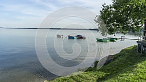 Fishing boats near shore. Small boats floating on the lake near the pier. Relax concept for design.