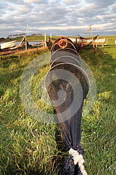 Fishing boats and net on field