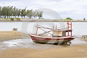 Fishing boats old red run aground