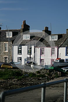 Fishing boats in a port in front of terraced houses, Dumfries and Galloway