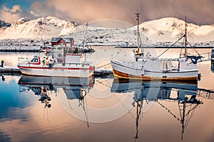 Fishing boats are preparing to go out to sea. Calm winter scene of Ramberg port photo