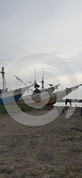 Fishing boats rest on the banks of the musi river palembang