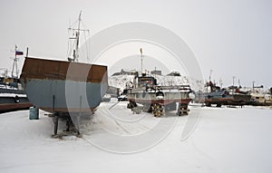 Fishing boats at rest on stands the shore