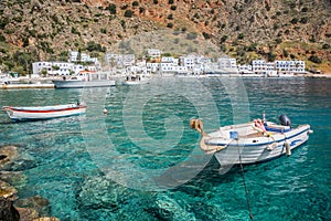 Fishing boats and the scenic village of Loutro in Crete Greece