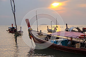 Fishing boats on the sea coast in the evening while sunset in Thailand
