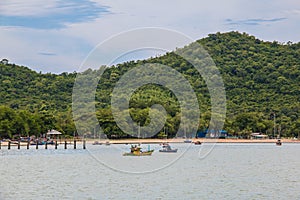Fishing boats in the sea with mountains in cloudy day , Chonburi province ,Thailand.