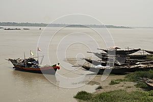 fishing boats in the shallow near river bank of bhagirathi river