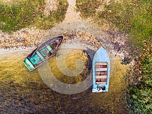 Fishing boats at the shore of the lake Kroman in Belarus. Drone aerial photo