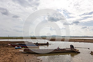Fishing boats on the shore of the Mekong River in thailand