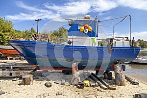 Fishing boats on stands waiting for maintenance