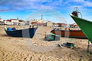 Fishing boats stranded on Aguda beach and little houses in the background
