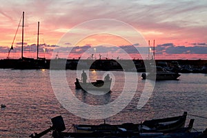 Fishing boats at sunset in port