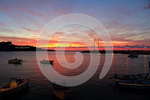 Fishing boats at sunset in port