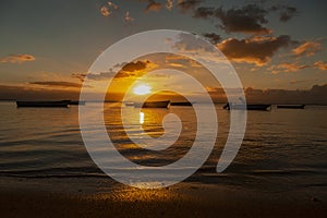 Fishing boats at sunset on the Public beach of Albion in the west of the republic of Mauritius.