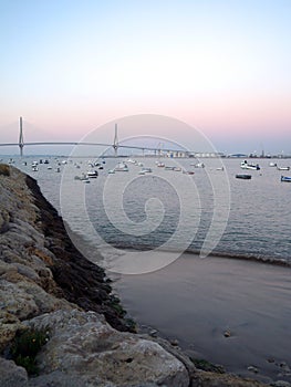 Fishing boats in sunset at the Puente de la ConstituciÃÂ³n, called La Pepa, in the bay of CÃÂ¡diz, Andalusia. Spain photo