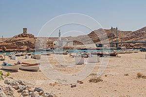 Fishing boats in Sur, Oman. Watchtower in Ayjah village in the backgroun