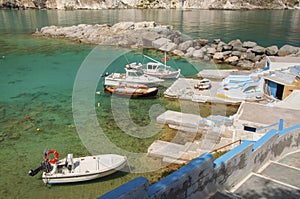Fishing boats and Syrmata fishermans houses at Milos island in Greece