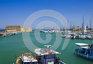 Fishing boats and Venetian Fortress in Heraklion, Crete, Greece