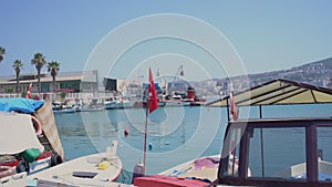 Fishing boats and vessels with turkish flag stands in row in Kusadasi city dock.