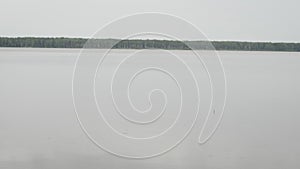 Fishing bobber floating on the surface of the water in rainy day.