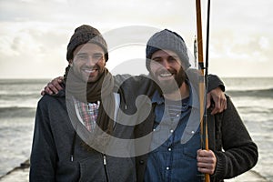 Fishing buddies. Portrait of two young fishermen in the early morning.