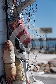 Fishing Buoys hanging on the side of a building