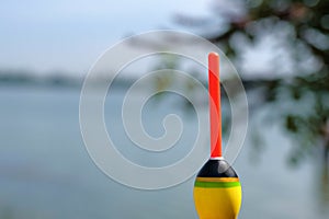 Fishing concept. Bobber on the background of the river close-up