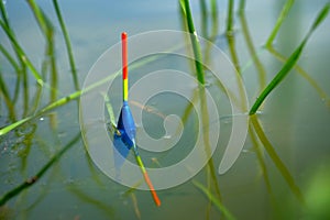 Fishing concept. Float in the river close-up. Fishing in the lake