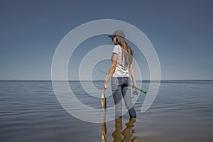 Fishing concept. Young fisherwoman with tackles and walleye zander fish at lake coast