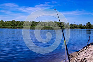 Fishing on the feeder on the shore of a beautiful river