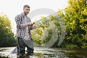 Fishing. Fisherman and trout. Fisherman on wild river.