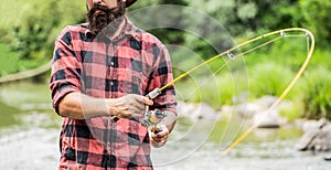 Fishing. Fisherman and trout. Fly Fishing Time. Fisherman with Fishing Rod on the Lake Shore. Fishing rod lake fisherman