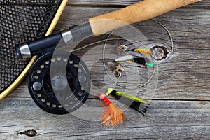 Fishing Fly reel with accessories on wood