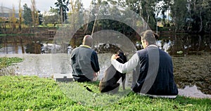 Fishing, friends and men with dog at a lake rear view, bond and fun with conversation in nature. Forest, break and back