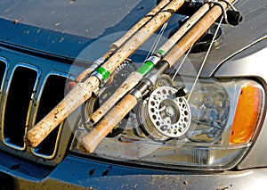 Fishing gear attached to car bonnet.