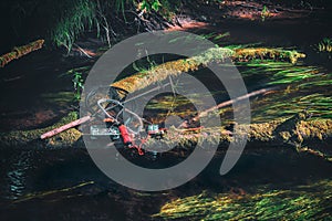 Fishing gear lying on the bank of a forest stream. Fly fishing and tenkara