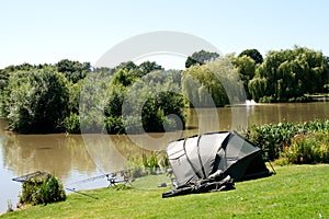 Fishing gear & tent beside lake