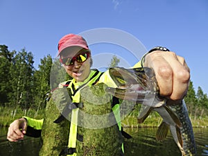 Fishing is a great catch. Caught fish in the hands of a happy fisherman.