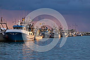 A fishing harbour at sunset.