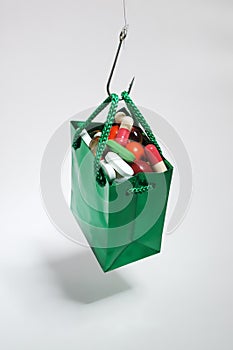 Fishing hook holding a green bag with medicines