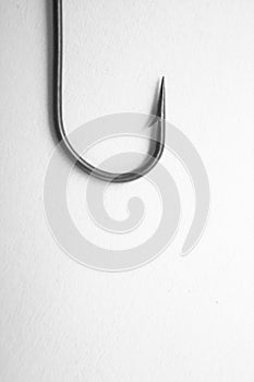 Fishing hook on a white paper background