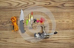 Fishing Kit with assorted equipment on aged wood