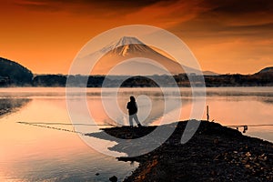 fishing at Lake against mt. fuji at dawn