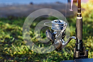 Fishing on the lake at sunset. Fisherman with rod, spinning reel on the river bank. Sunrise. Fishing for pike, perch, carp. Fog