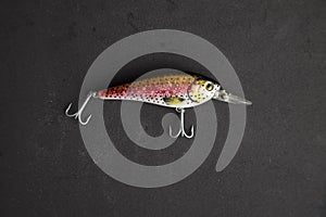 Fishing lure in the shape of fish on a black background