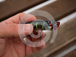 Fishing lures and accessories in the box background. Focus in the center of the bait